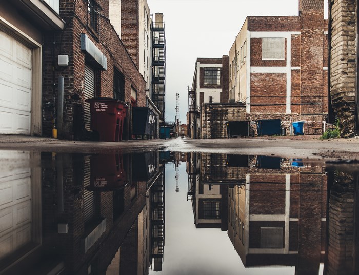 Alleyway with puddles and reflections