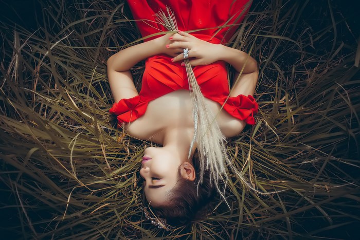 Sleeping Woman in Red Dress Lying in Grass