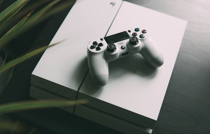 White PlayStation 4 console with controller
