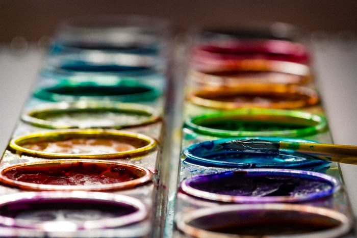 Watercolor paint palette with a paintbrush