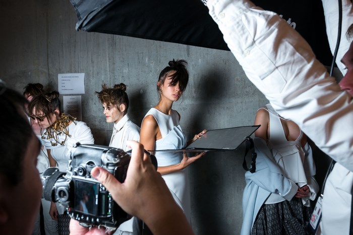 Fashion photoshoot behind the scenes with models and photographer