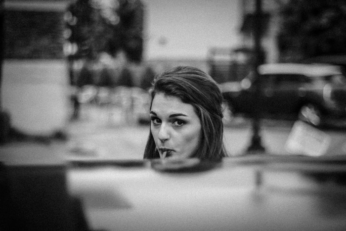 Woman drinking from a straw in black and white