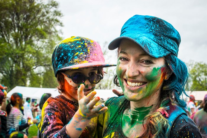 Mother and child covered in colorful powder