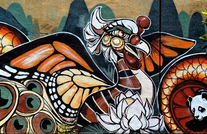 Graffiti mural of mythical creatures and a panda