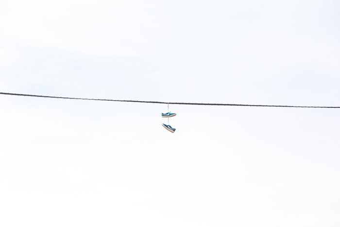 Blue Nike sneakers hanging on a wire