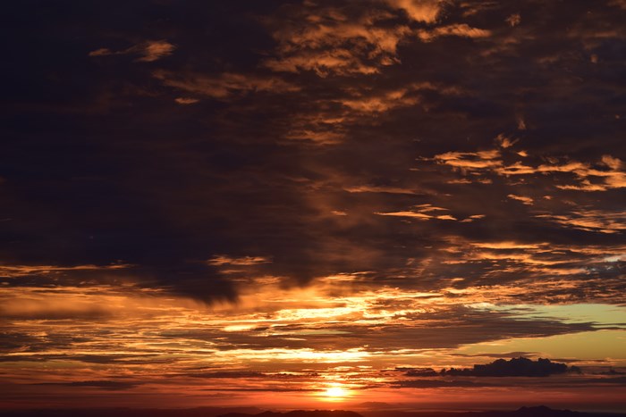 Sunset over mountains with dramatic clouds