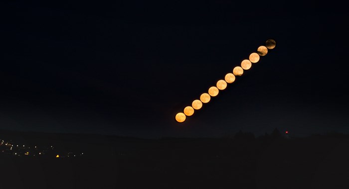 Moon phases in a diagonal line across the night sky
