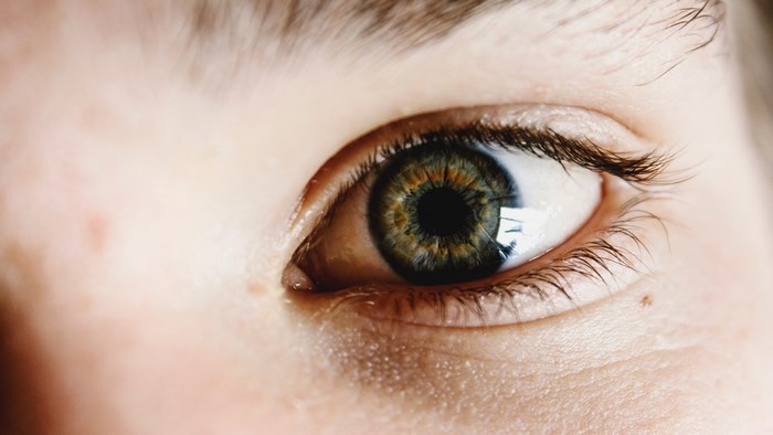 Close-up of a human eye with green and brown iris