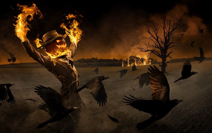 Scarecrow with flaming head and burning barn