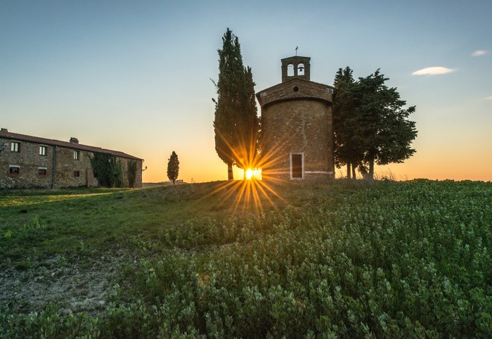 Chapel and farmhouse at sunset in Tuscany