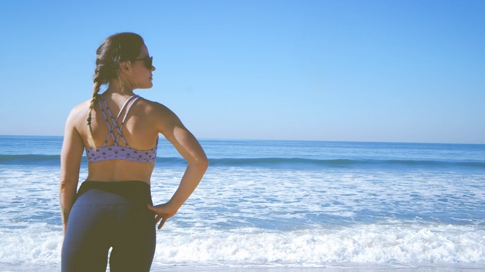 Woman in workout clothes on a beach
