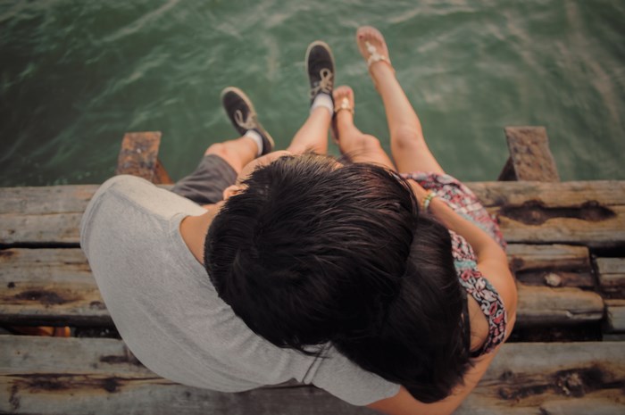 Couple sitting on a dock by the water
