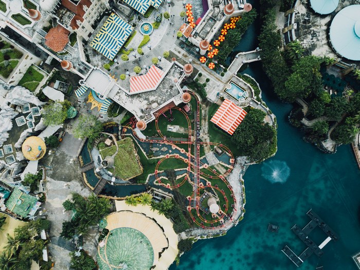 Aerial view of a theme park with a roller coaster and water features