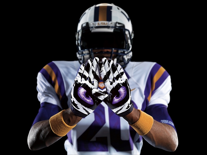 LSU football player wearing tiger-themed gloves