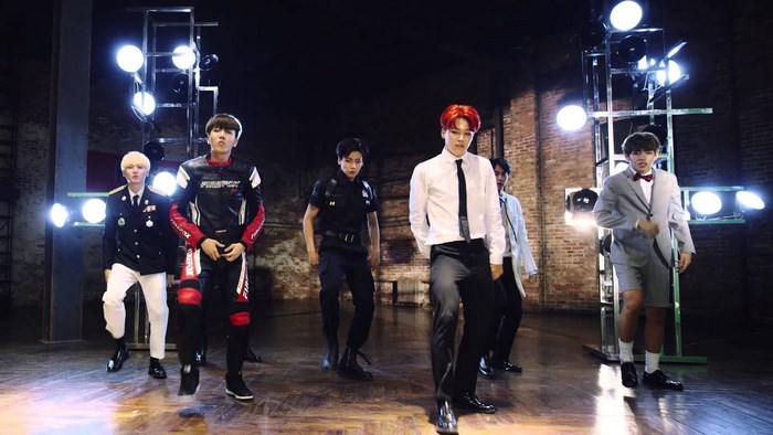BTS members in stylish outfits on stage