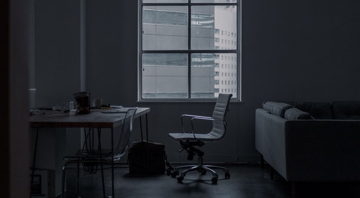Office interior with desk, chair, and sofa