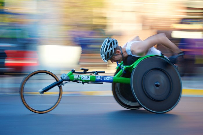 Athlete racing in a wheelchair with motion blur