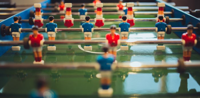 Table football game with red and blue players