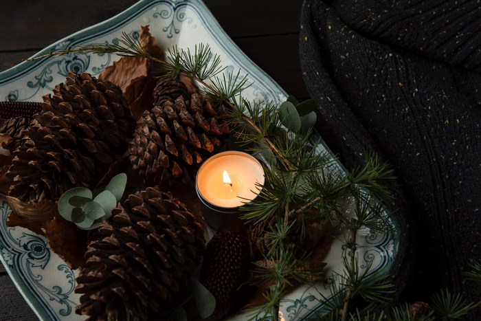 Cozy Autumn Pinecones and Candlelit Arrangement