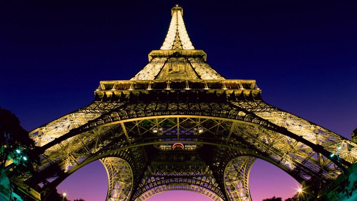 Eiffel Tower illuminated at night in Paris