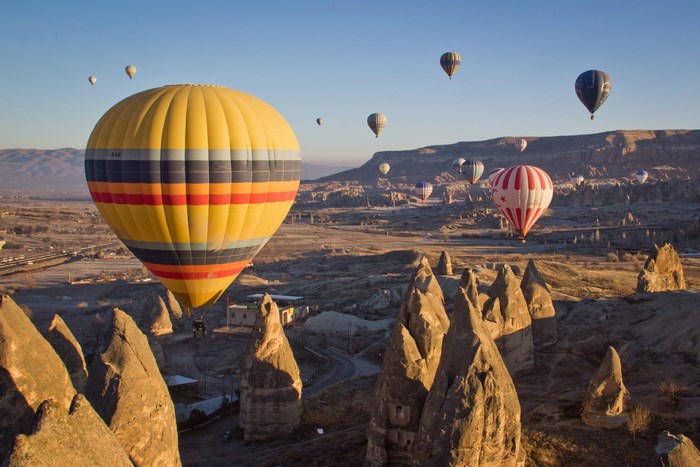 Hot air balloons over Cappadocia landscape