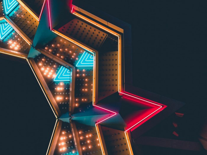 Star-shaped neon sign with lights at night