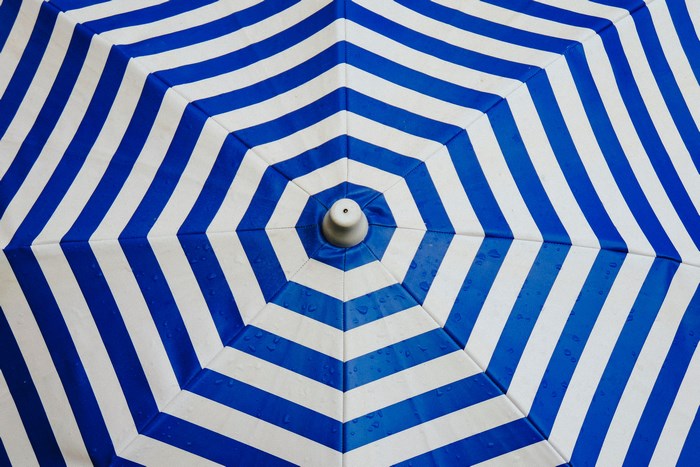 Blue and white striped umbrella with raindrops