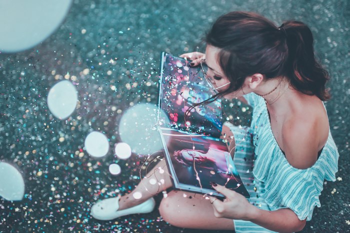 Woman reading a book with glitter and bokeh