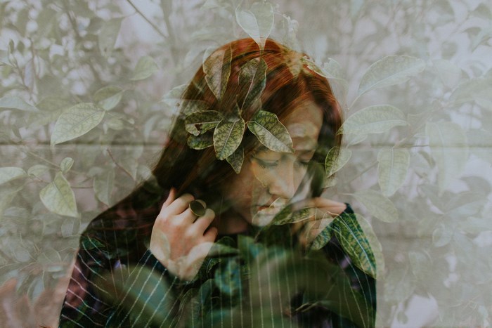 Double exposure portrait of a woman with leaves