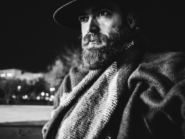 Man in hat and scarf at night