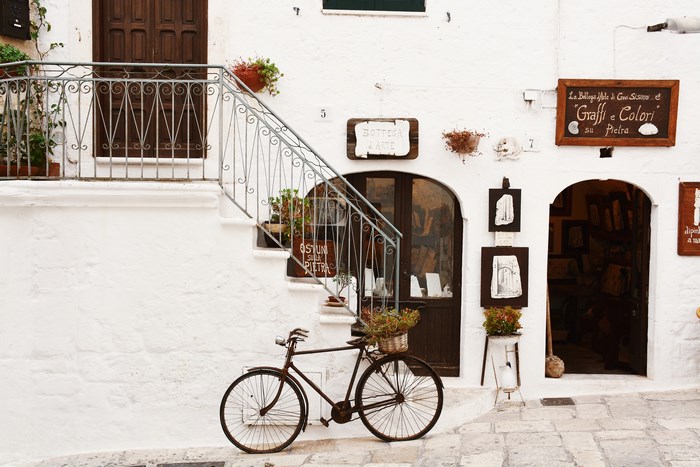 Italian street with a vintage bicycle and shops