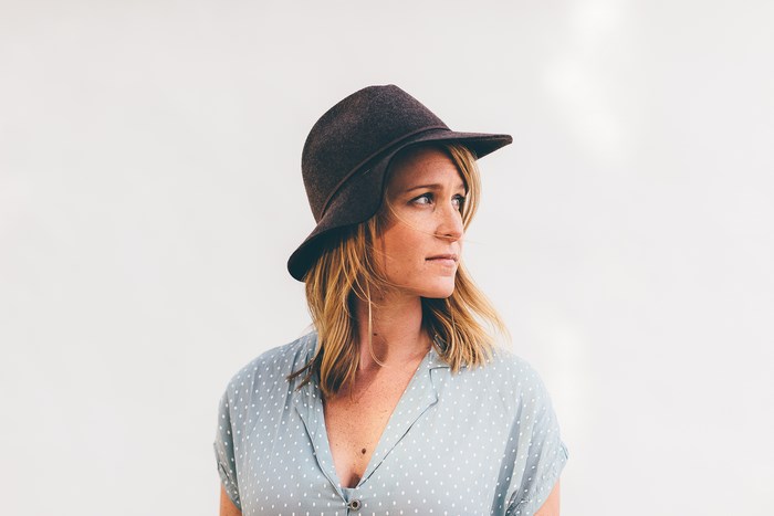 Woman wearing a fedora and polka dot dress