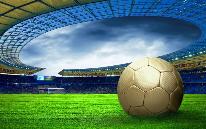 Golden Soccer Ball on Stadium Field