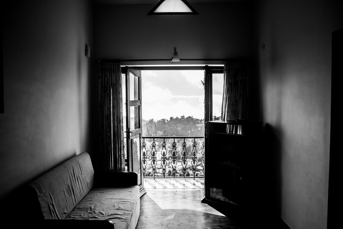 Interior view of a room with a balcony and sofa