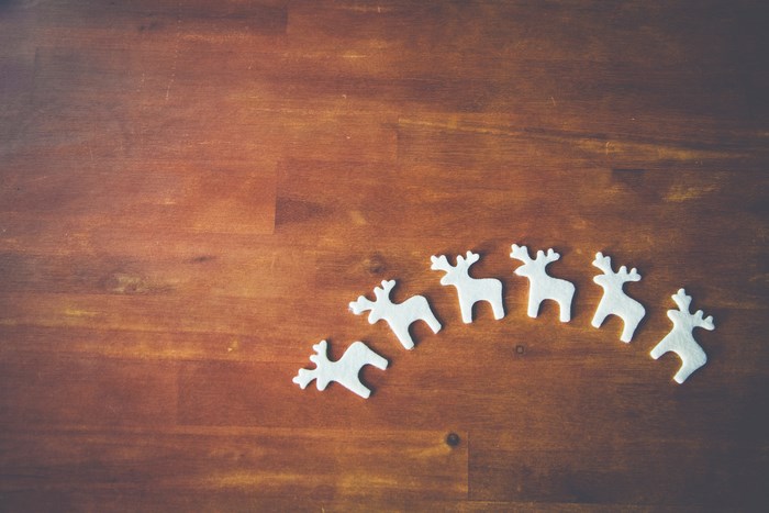 White Felt Reindeer Decorations on Wooden Table