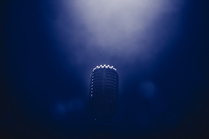 Retro microphone in blue smoke and light