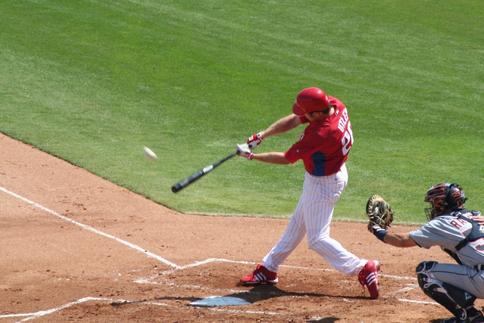 Baseball player hitting a ball