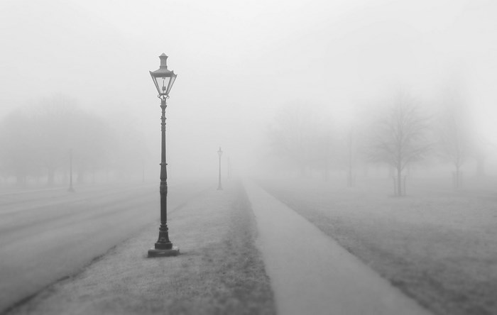 Street lamp on a foggy path in England