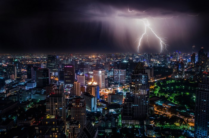 Lightning strikes a city skyline at night