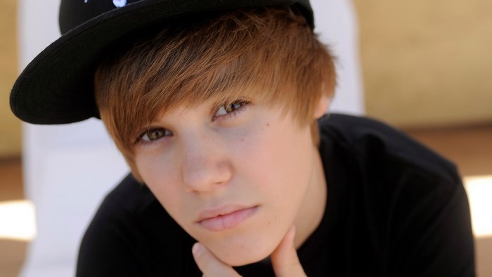 Justin Bieber wearing a black hat and shirt