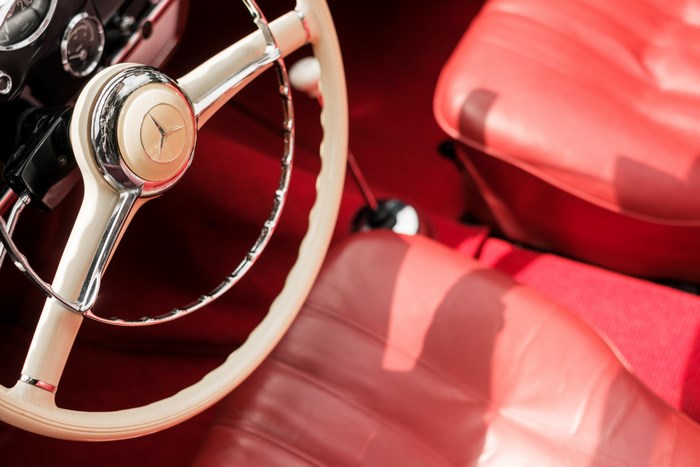 Mercedes vintage car interior with red seats and steering wheel