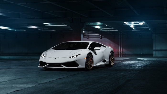 White Lamborghini Huracan in a parking garage