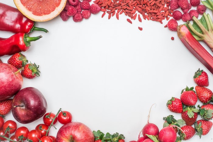 Assortment of Red Fruits and Vegetables on White Background