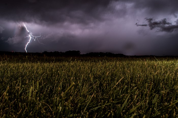 Lightning Strikes Over a Dark Night Field