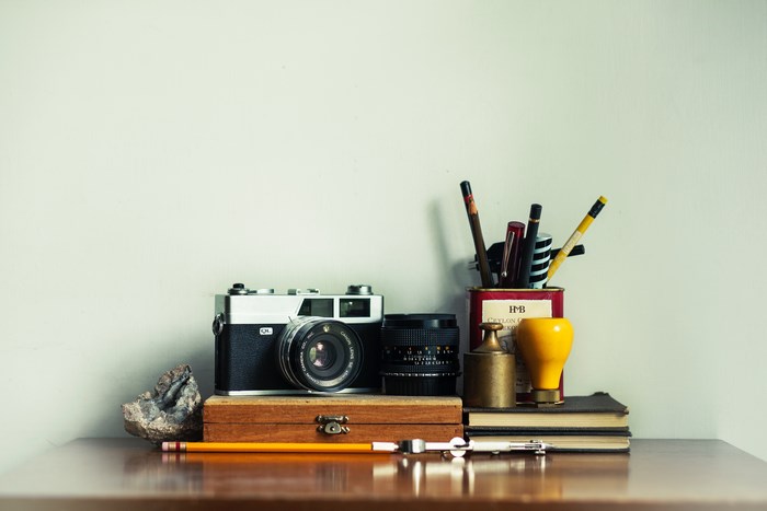 Vintage Camera and Art Supplies on a Desk