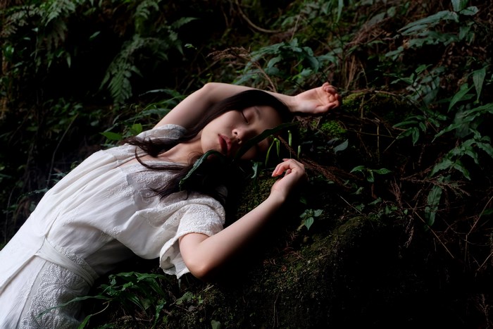 Asian woman sleeping in a forest