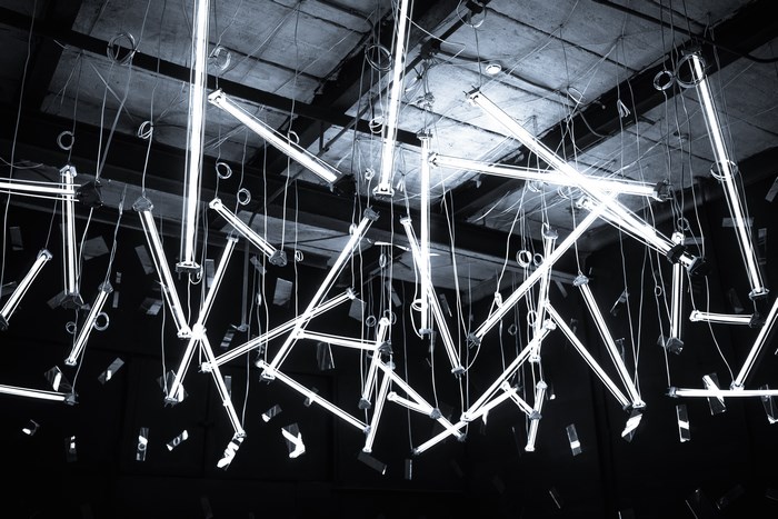 Hanging illuminated striplights in an industrial setting