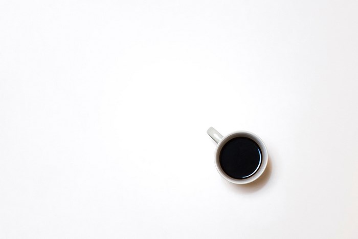 Minimalist coffee cup on white surface