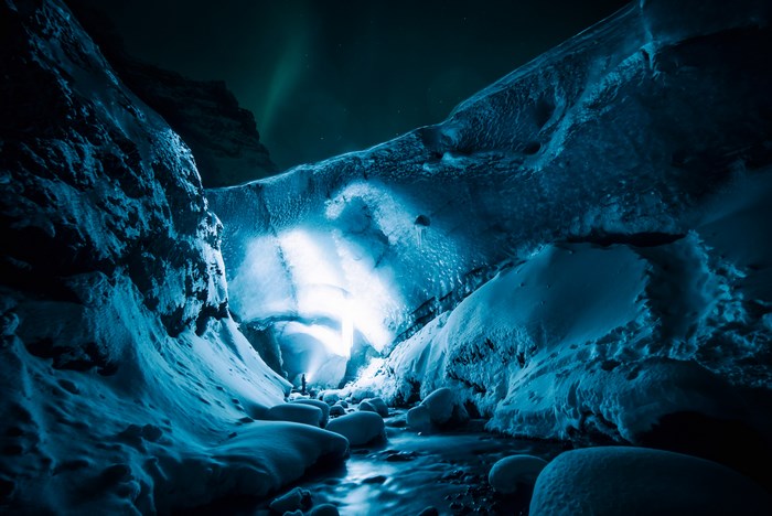 Glowing Blue Ice Cave with Northern Lights in Iceland