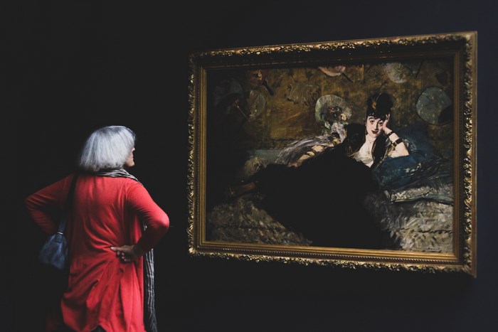 Woman Admiring a Painting in a Museum